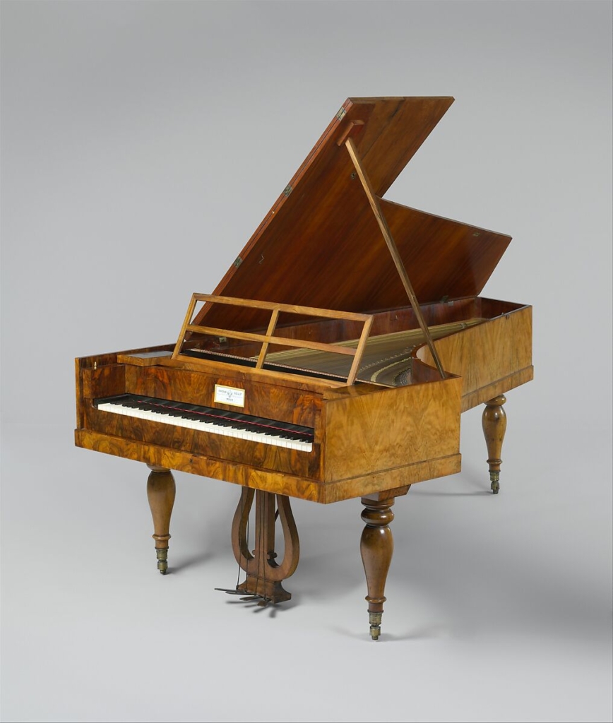 Early 19th-century fortepiano with light wooden frame and hammer action, representing the transitional keyboard instrument that replaced the harpsichord and shaped Classical keyboard music.