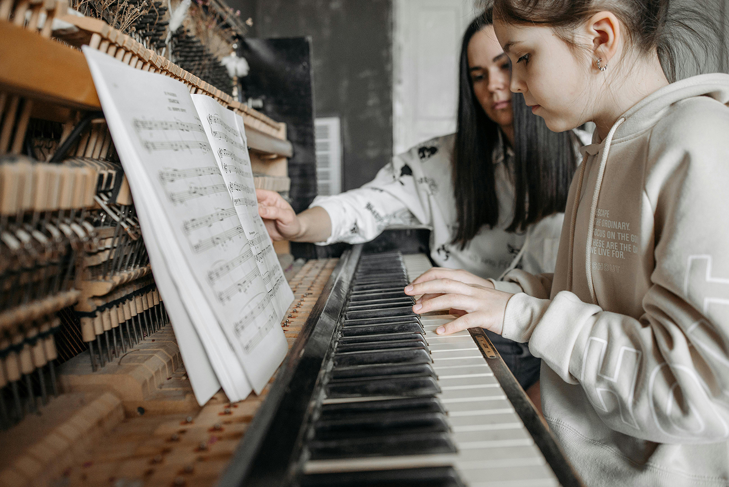 Child learning piano during early music education, illustrating aspects of Korean music education culture