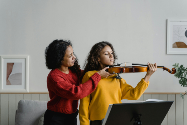 Young student practicing violin, related to discussions about Korean music education and long-term instrument learning